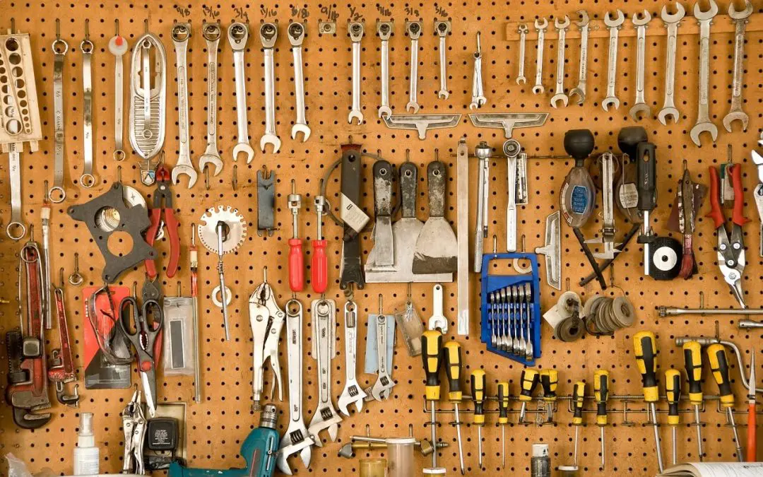 a series of tools neatly arranged on pegboard