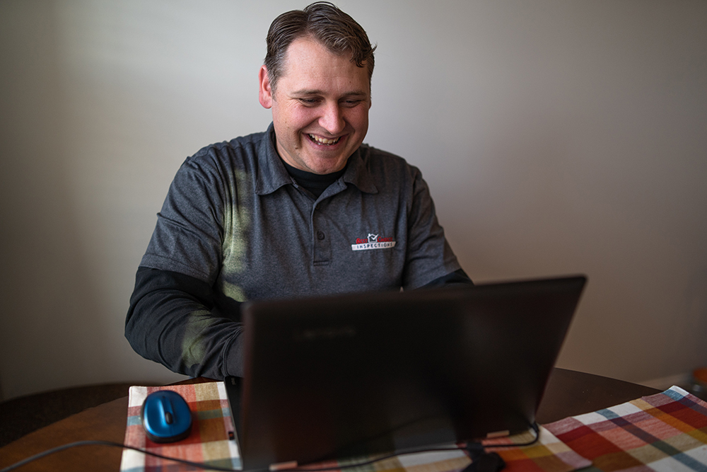 Master Home Inspector Jon looking at a laptop